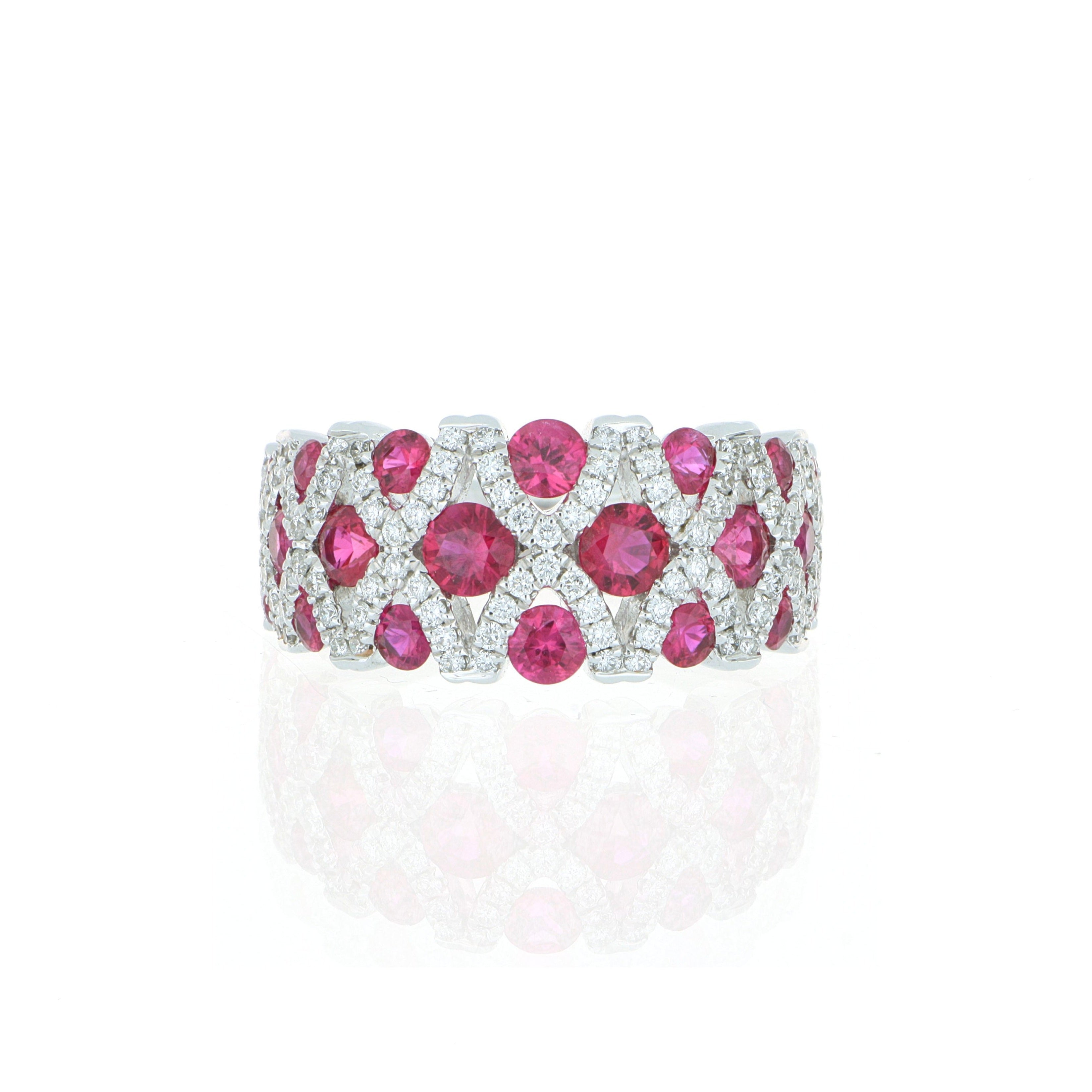 Ring with pink gemstones and diamond accents on a white background